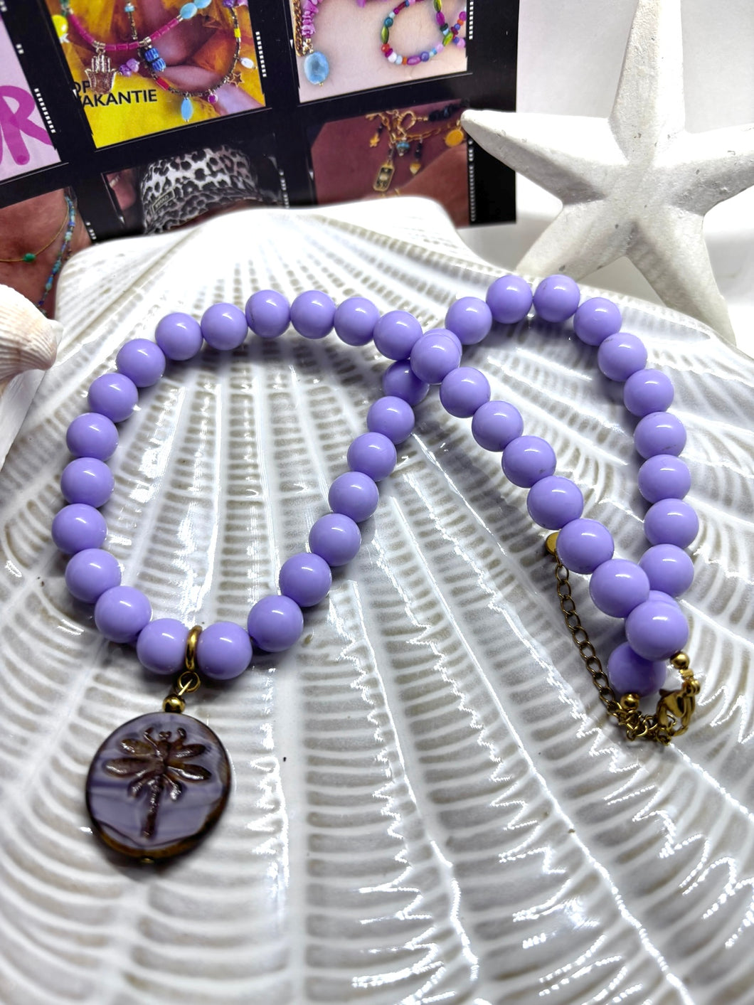 Lila Kralenketting met afneembare firefly bedel
