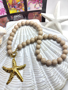 Beige Kralenketting met boeislot en zeester bedel